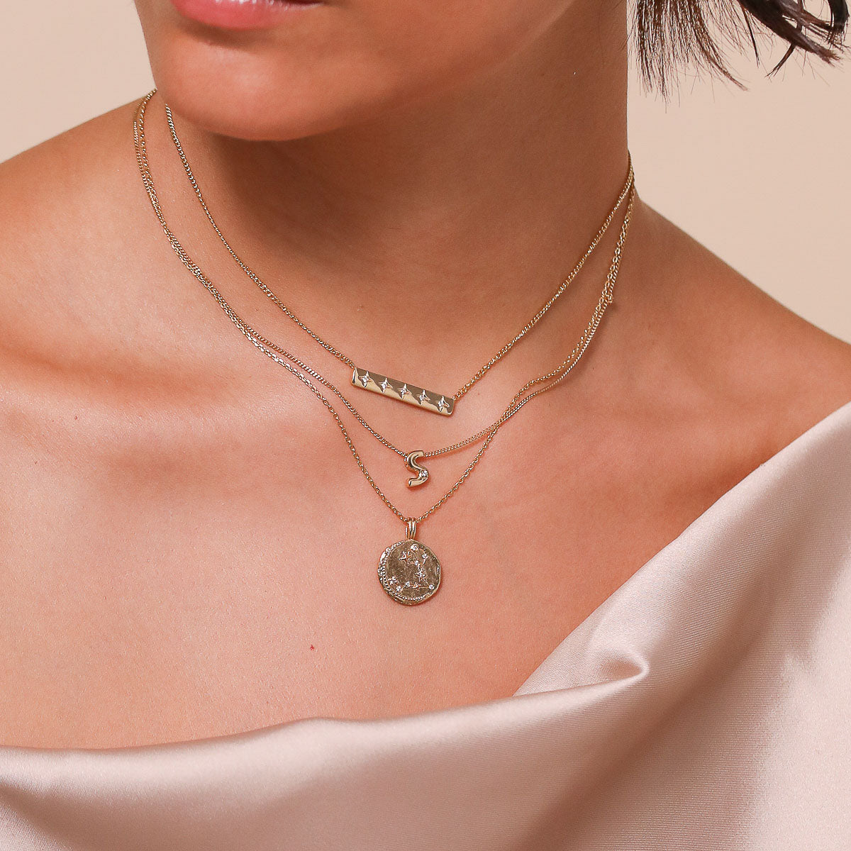 Pisces Zodiac Pendant Necklace in Gold worn layered with necklaces